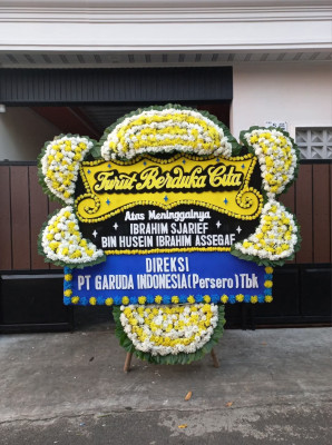 Papan Bunga Duka di Punggung Lading