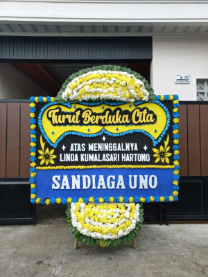 Papan Bunga Duka di Punggung Lading